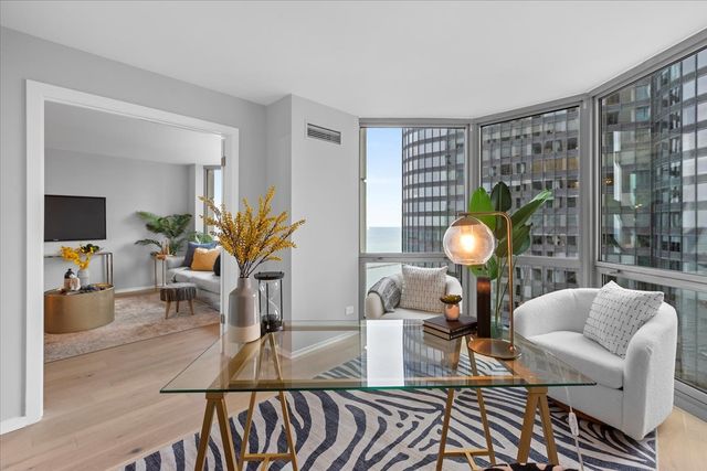 a living room with furniture a lamp and a potted plant