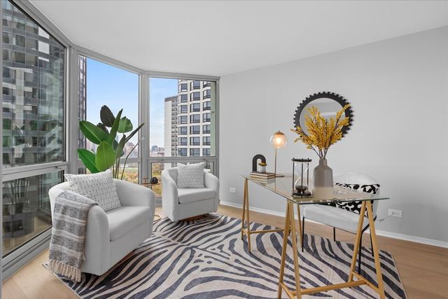a living room with furniture a rug and a large window