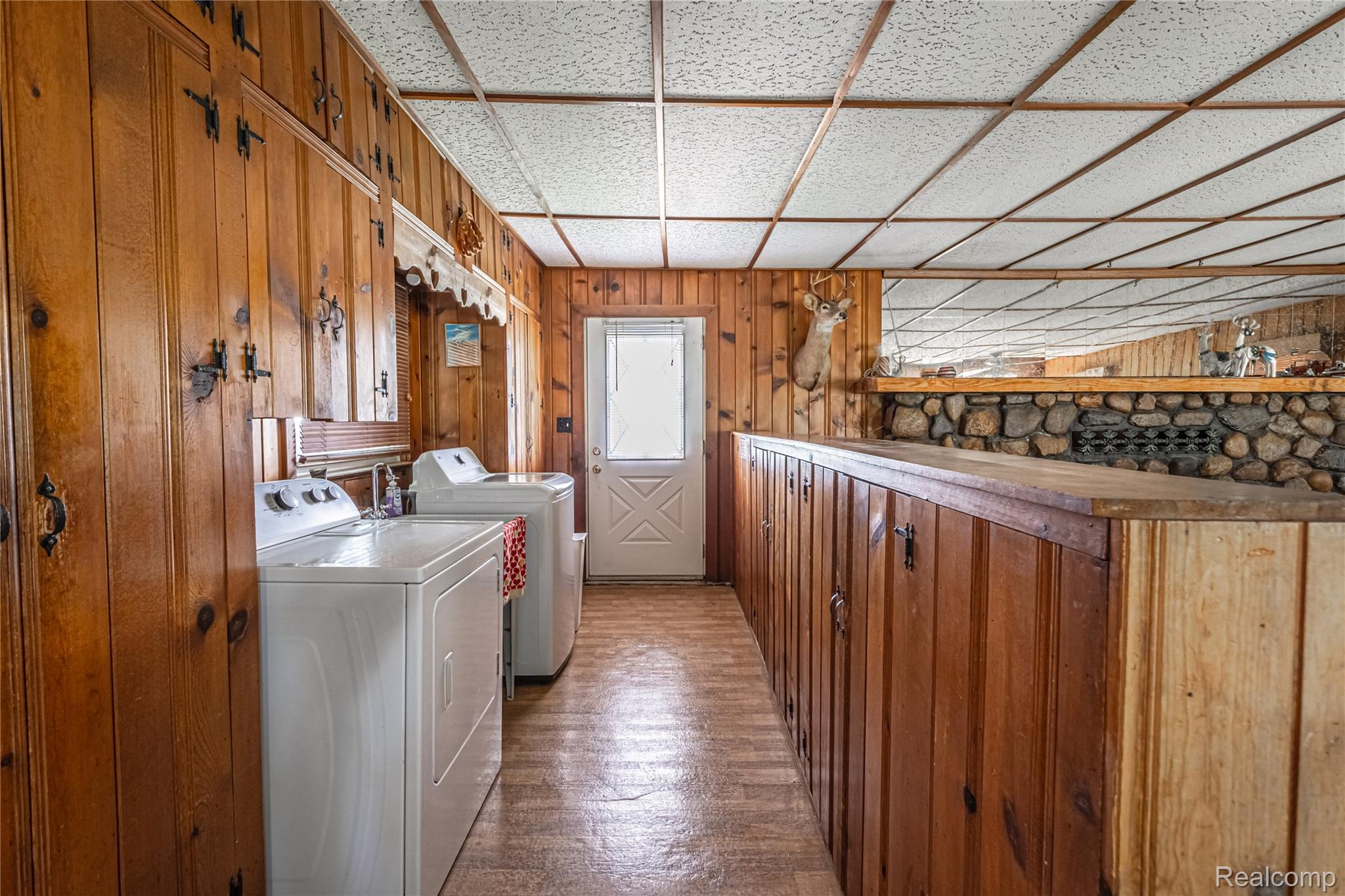 8384 Imlay City Road Avoca, MI 48006 - Photo 22 of 39 Laundry area featuring wood-paneled walls and built-in cabinetry