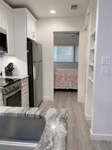 a kitchen with refrigerator a stove and a refrigerator