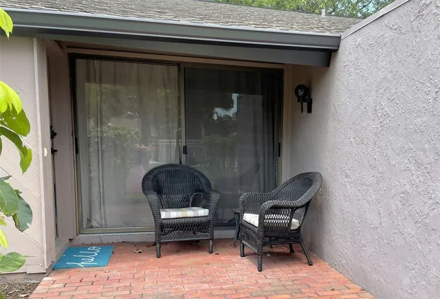 a backyard of a house with couch and outdoor seating