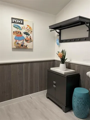 a room that has a painting on the wall and a table