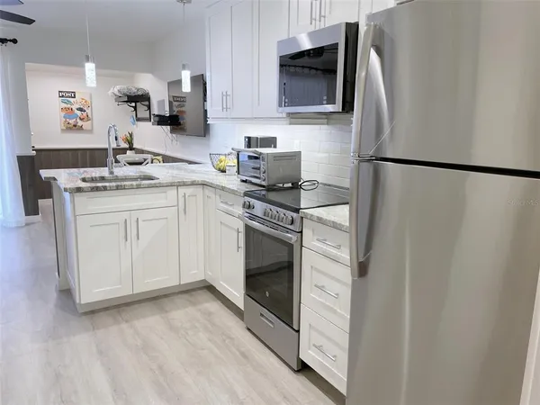 a kitchen with a sink cabinets and stainless steel appliances