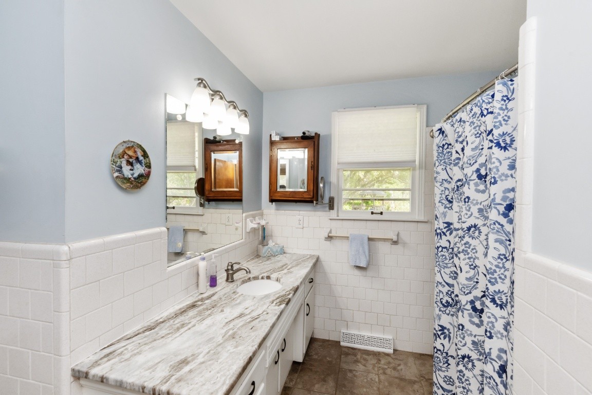 5895 Murfreesboro Road Lebanon, TN 37090 - Photo 13 of 31 a bathroom with a double vanity sink mirror and shower
