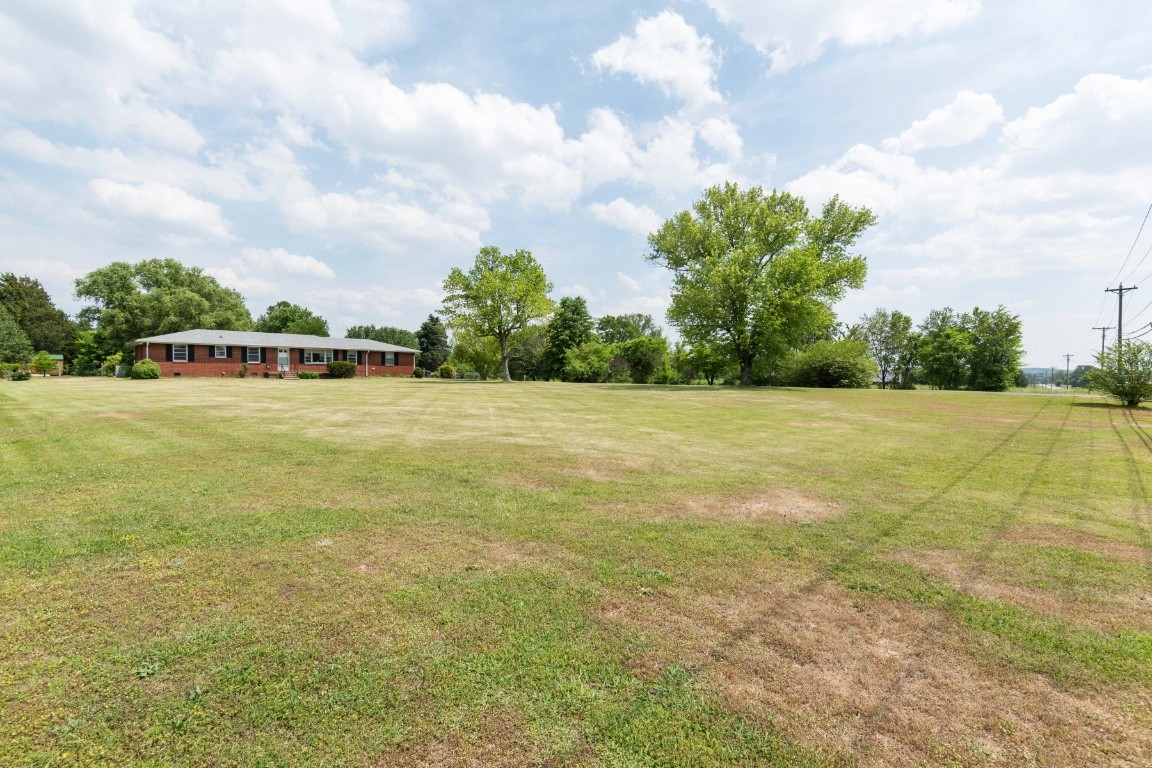 5895 Murfreesboro Road Lebanon, TN 37090 - Photo 3 of 31 a view of a swimming pool with an outdoor seating and a yard