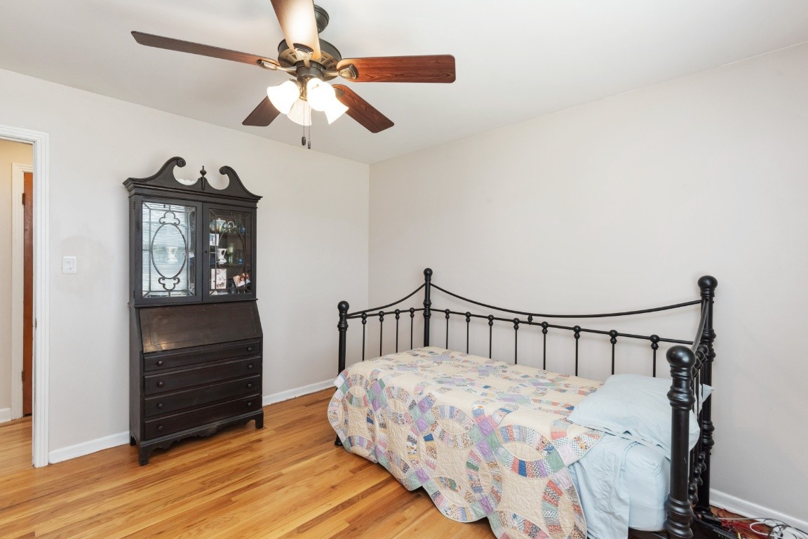5895 Murfreesboro Road Lebanon, TN 37090 - Photo 21 of 31 a bedroom with a bed a dresser and wooden floor