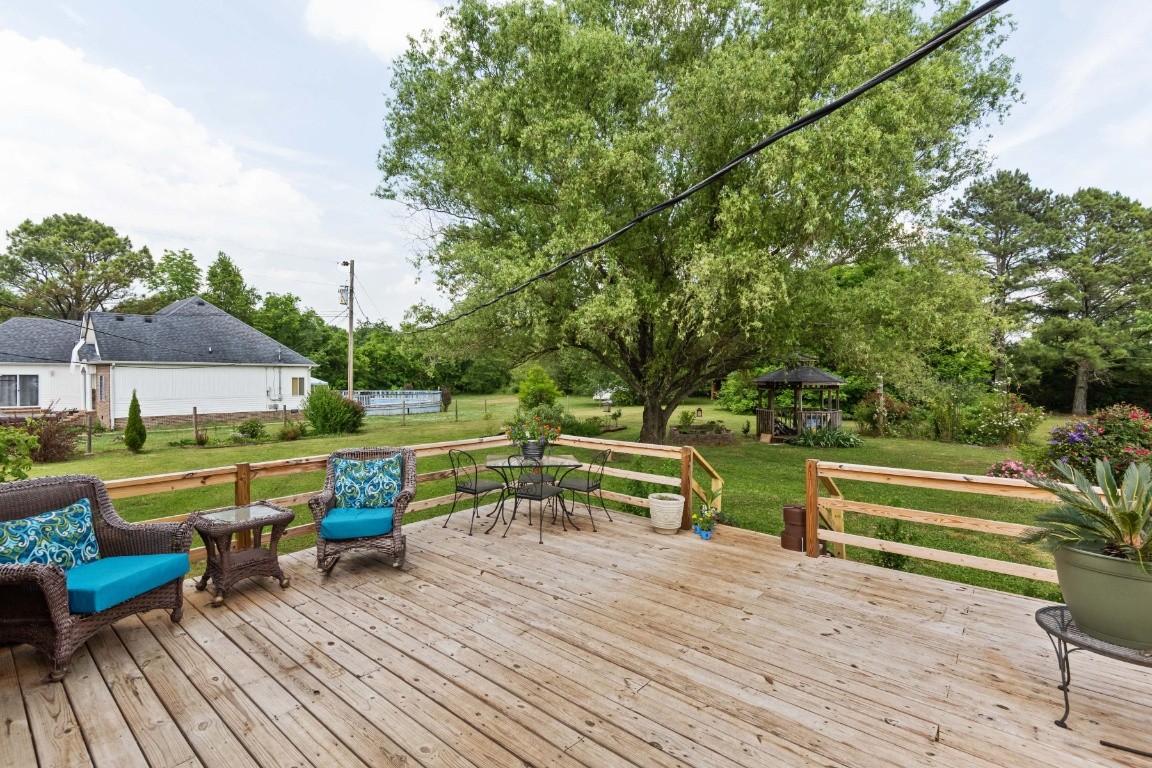 5895 Murfreesboro Road Lebanon, TN 37090 - Photo 22 of 31 a view of house with deck outdoor seating and trees in the background