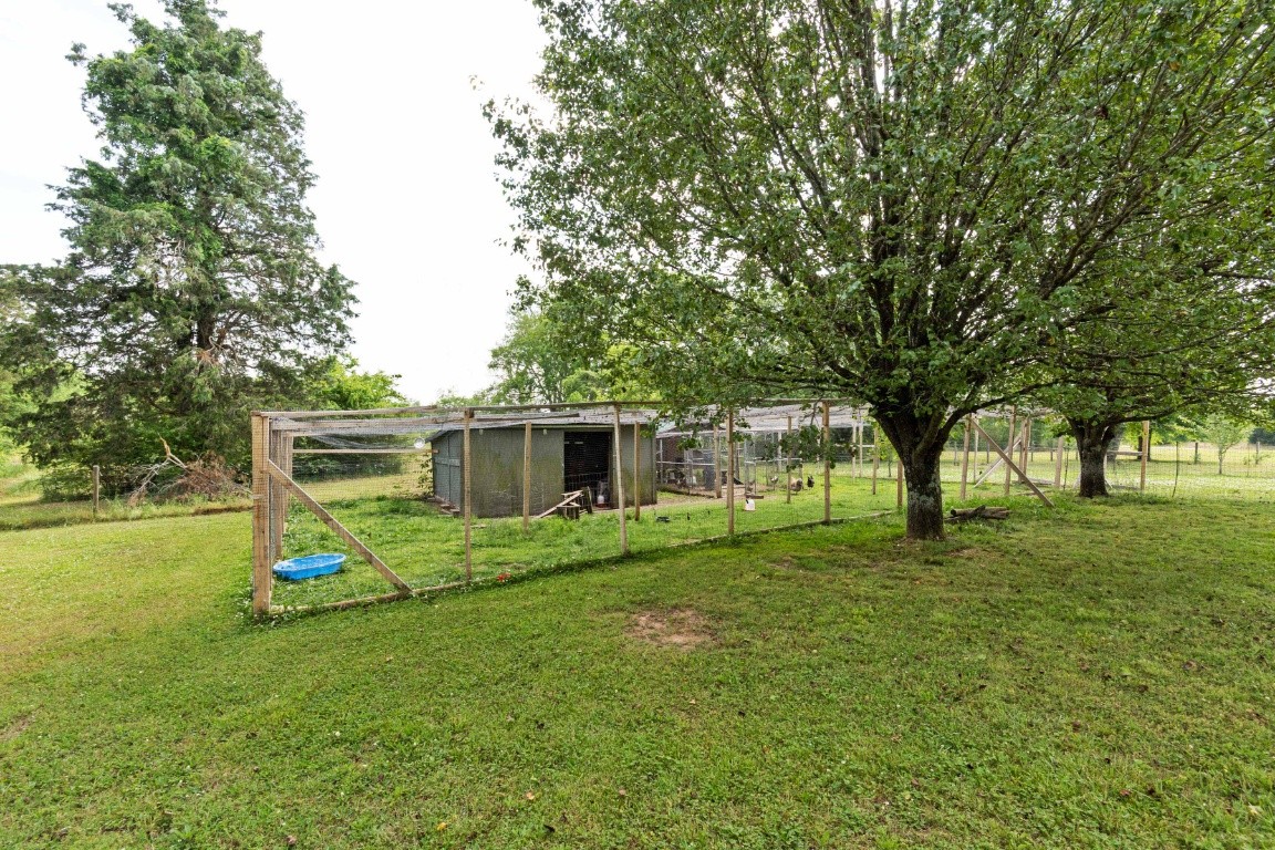 5895 Murfreesboro Road Lebanon, TN 37090 - Photo 27 of 31 a view of a backyard with table and chairs and a large tree