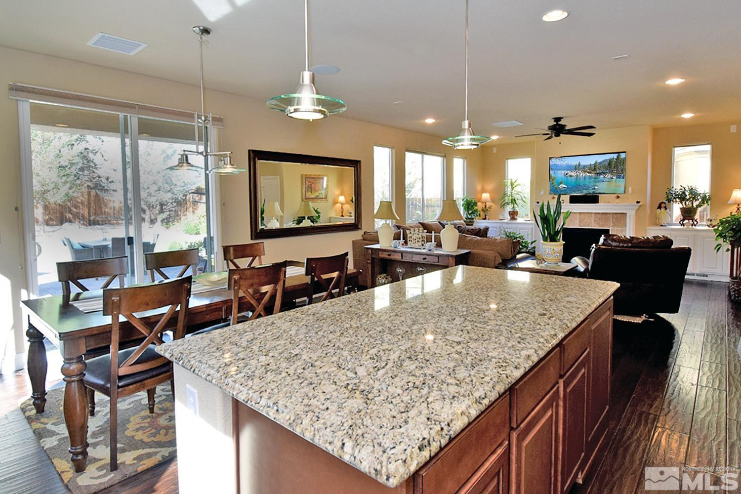 10685 Solano Court Reno, NV 89521 - Photo 11 of 32 a view of a kitchen with kitchen island granite countertop a large island in the center