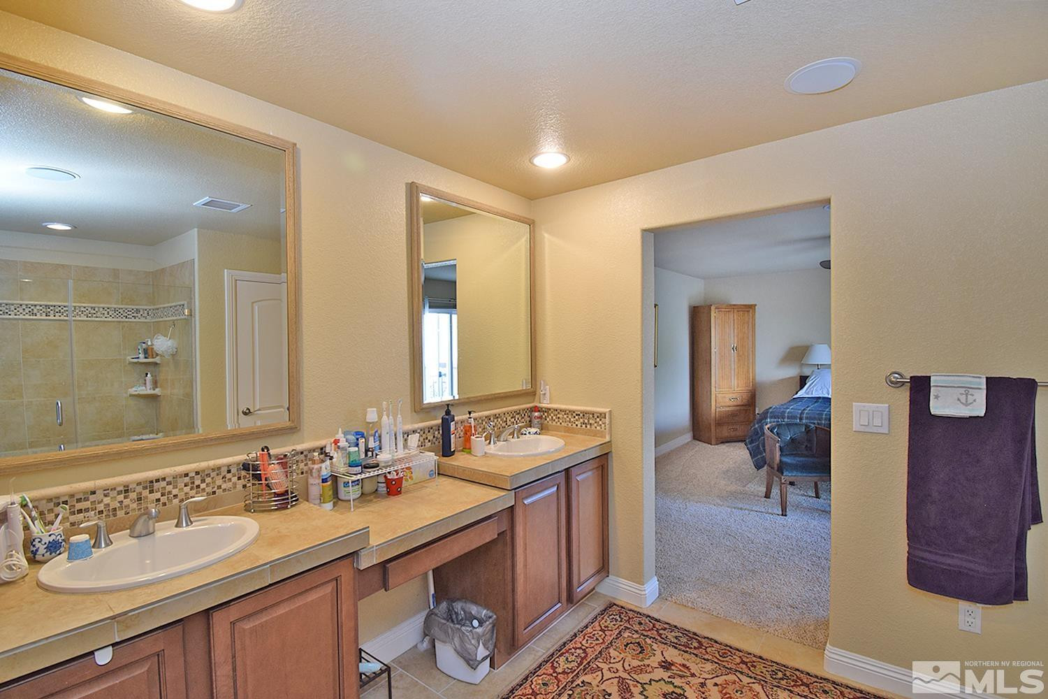 10685 Solano Court Reno, NV 89521 - Photo 23 of 32 a bathroom with a sink double vanity and a mirror