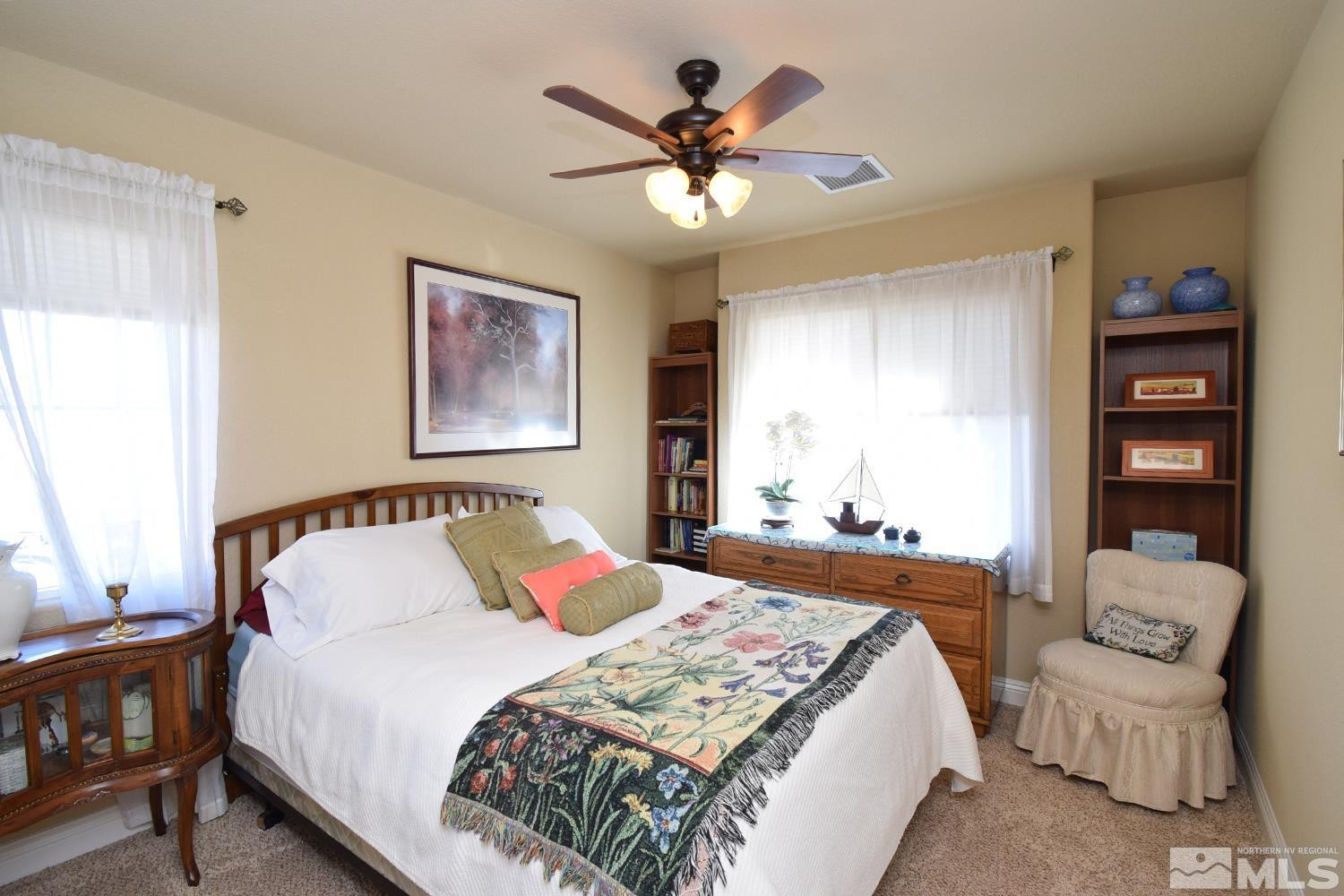 10685 Solano Court Reno, NV 89521 - Photo 25 of 32 a bedroom with a bed and ceiling fan