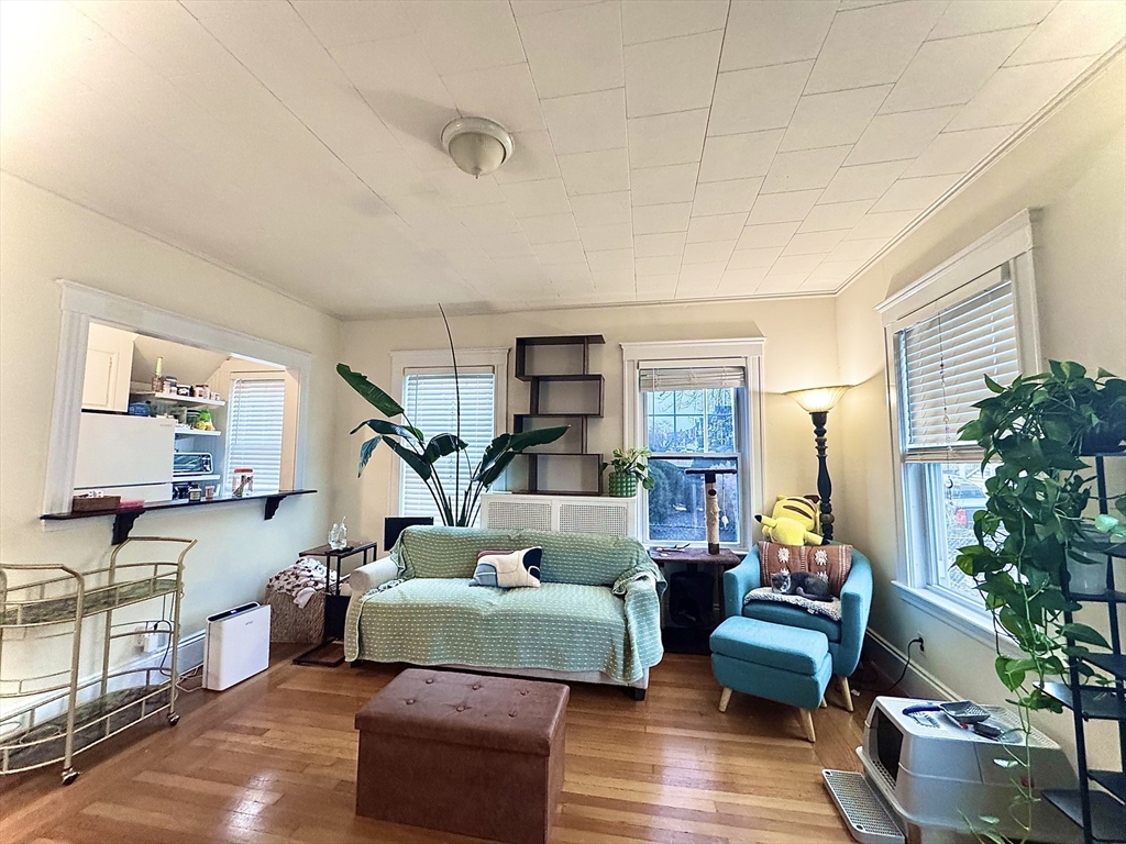 2 Mapleton Street, Unit 1 Boston, MA 02135 - Photo 3 of 8 a living room with furniture and a wooden floor