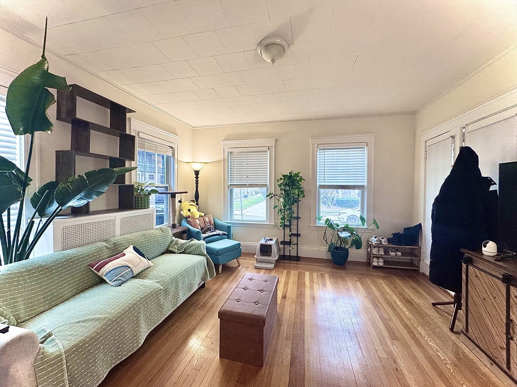 2 Mapleton Street, Unit 1 Boston, MA 02135 - Photo 4 of 8 a living room with furniture and a fireplace