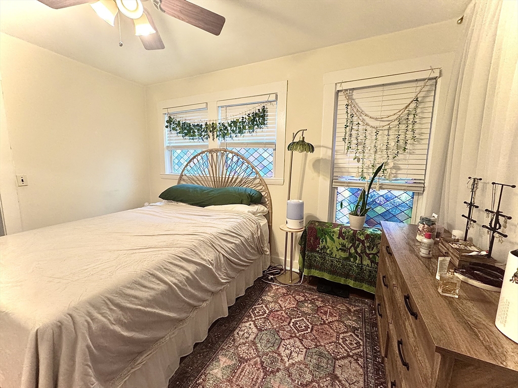 2 Mapleton Street, Unit 1 Boston, MA 02135 - Photo 5 of 8 a bedroom with a bed and a table