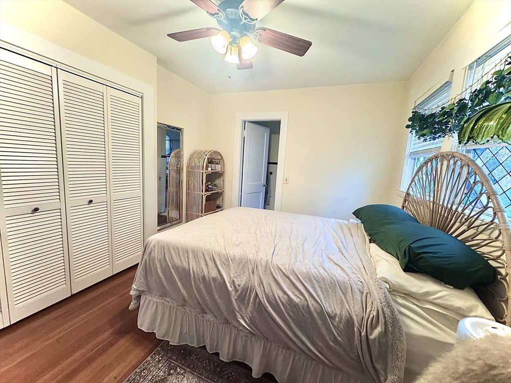 2 Mapleton Street, Unit 1 Boston, MA 02135 - Photo 6 of 8 a bedroom with a bed and a chandelier