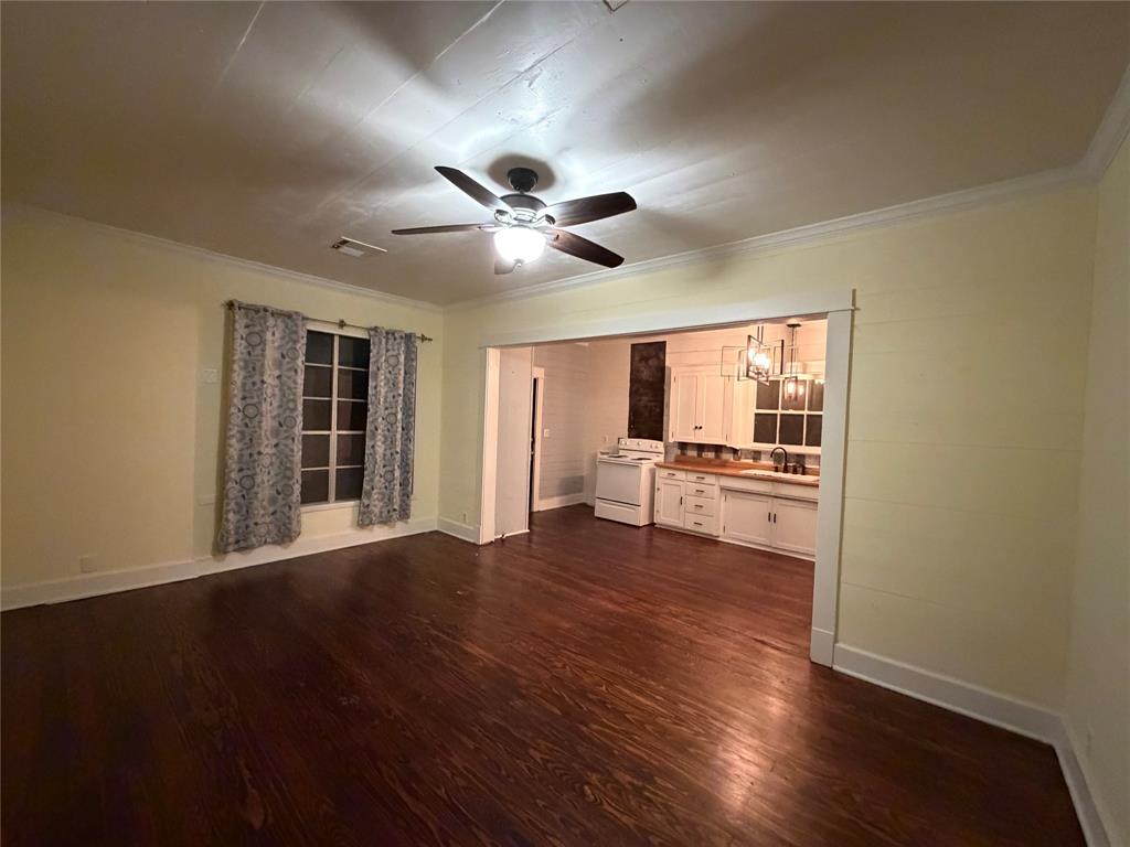 821 Ward Street Marlin, TX 76661 - Photo 16 of 22 a view of an empty room with wooden floor and a window