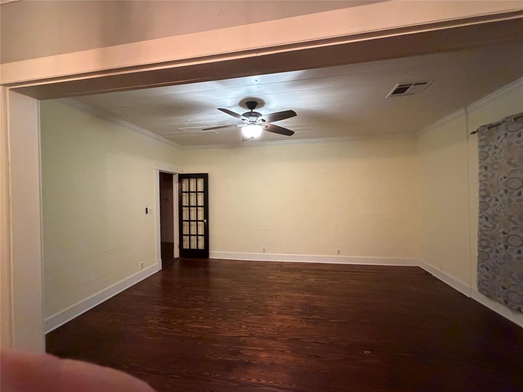 821 Ward Street Marlin, TX 76661 - Photo 22 of 22 an empty room with a ceiling fan and wooden floor