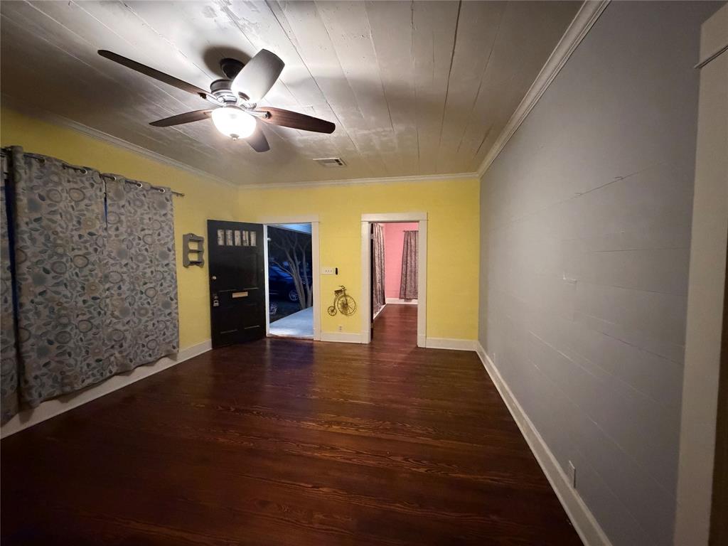 821 Ward Street Marlin, TX 76661 - Photo 7 of 22 wooden floor in an empty room with a window
