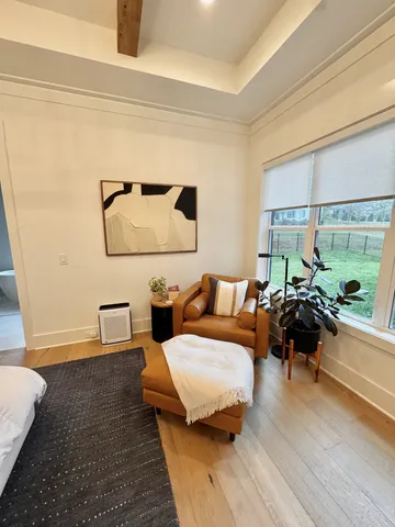 a bedroom with a bed and a large window