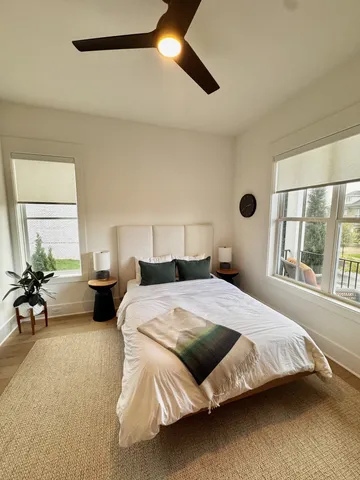 a view of a brick house with a big yard and large trees