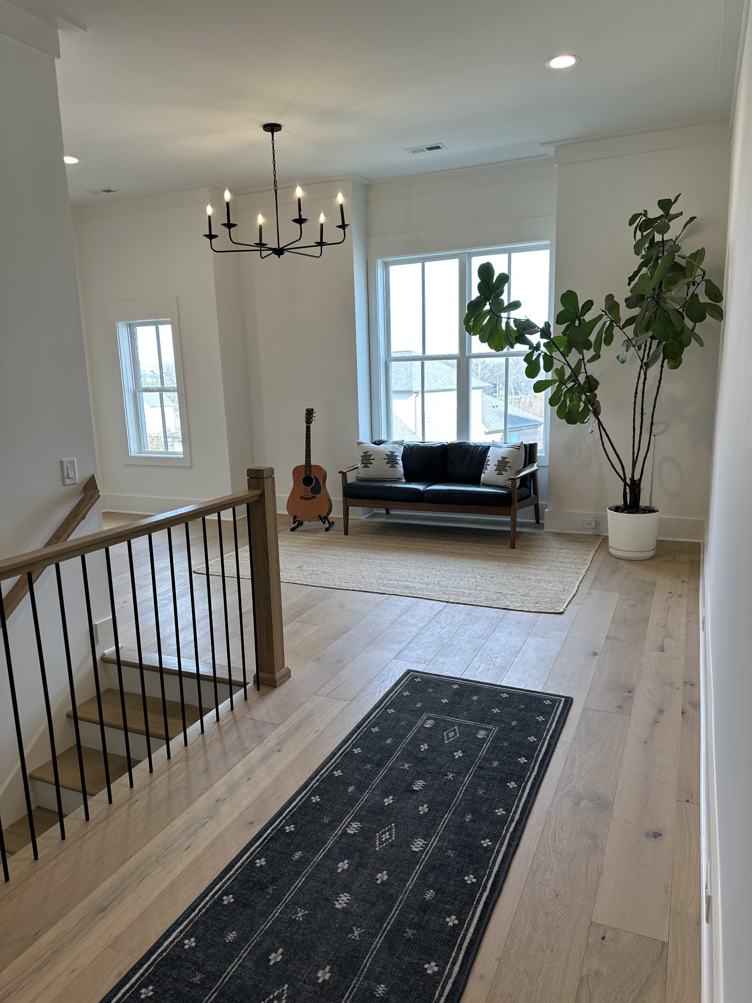 2725 Otterham Drive Thompson's Station, TN 37179 - Photo 22 of 36 a living room with furniture and a chandelier