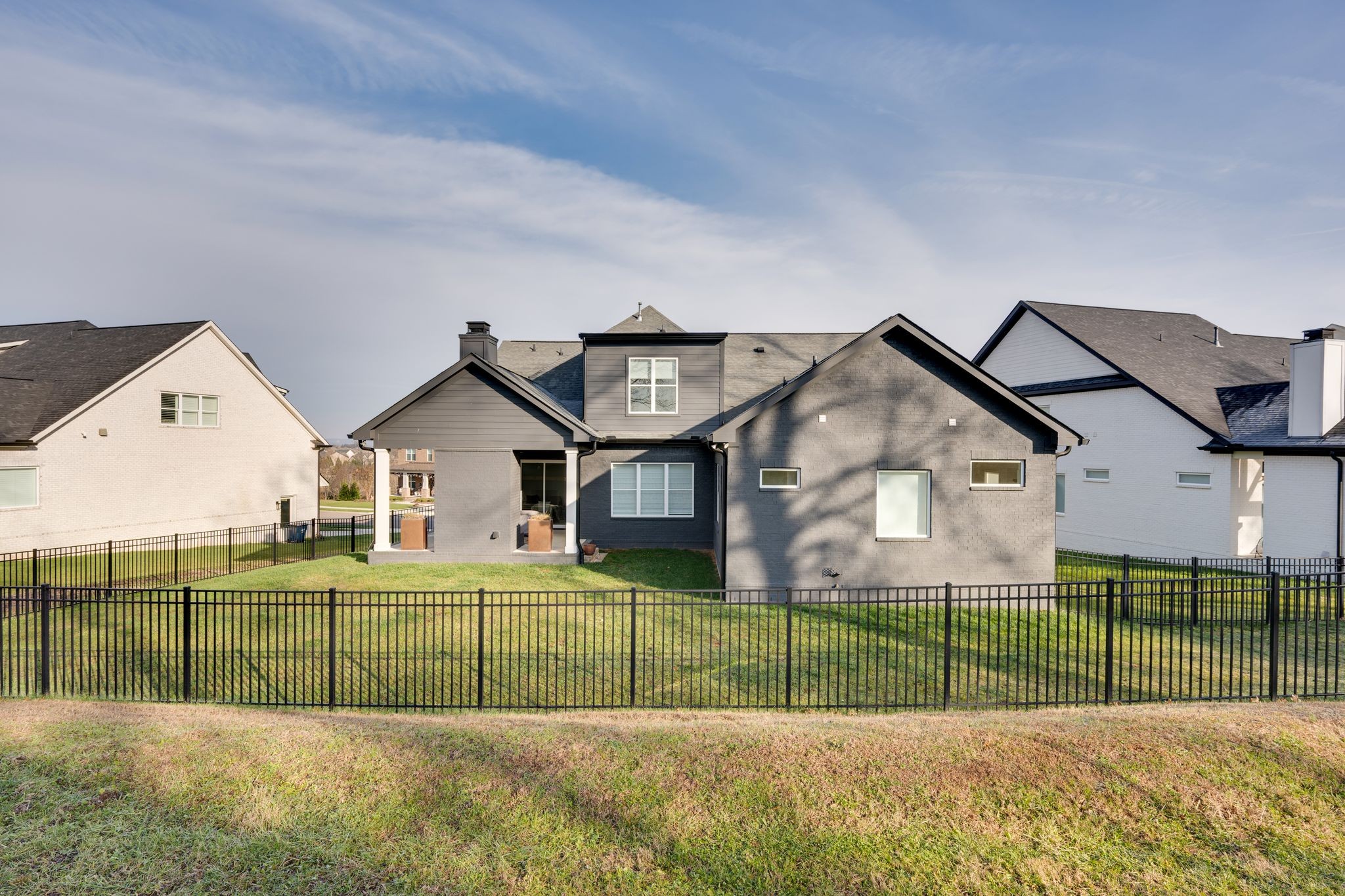 2725 Otterham Drive Thompson's Station, TN 37179 - Photo 32 of 36 a view of a brick house with a big yard and large trees