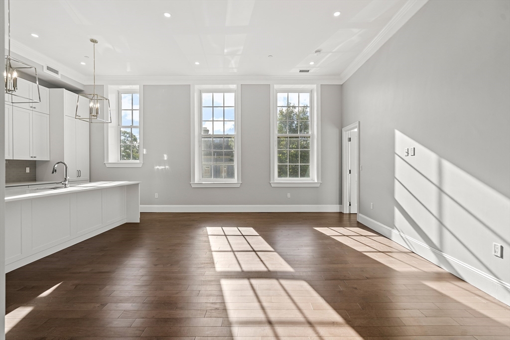 20 Mechanic Square, Unit 2 Marblehead, MA 01945 - Photo 12 of 42 a view of an empty room with window and wooden floor