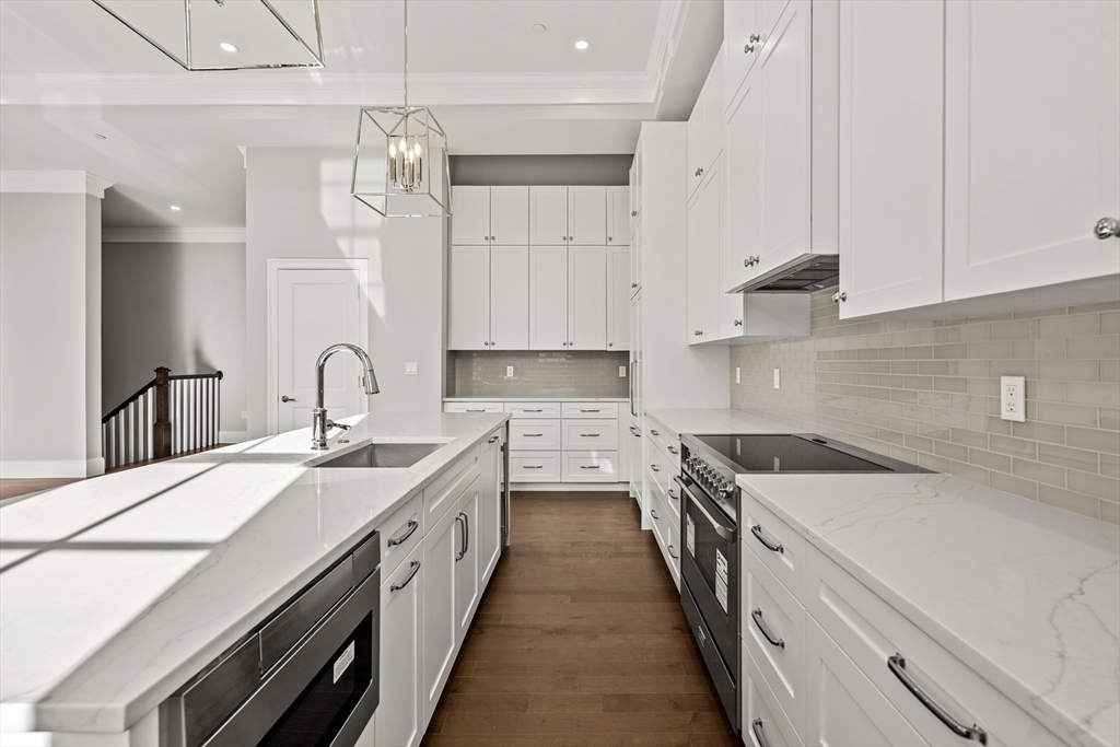 20 Mechanic Square, Unit 2 Marblehead, MA 01945 - Photo 15 of 42 a kitchen with a sink stove and cabinets