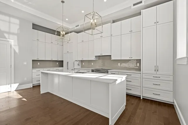 a kitchen with white cabinets and white appliances