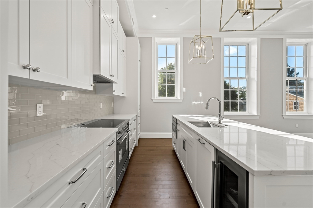 20 Mechanic Square, Unit 2 Marblehead, MA 01945 - Photo 18 of 42 a kitchen with granite countertop a sink stove and cabinets