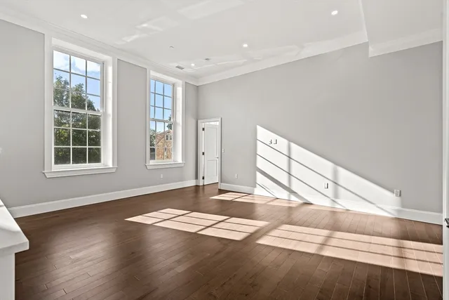 a view of a livingroom with wooden floor and window