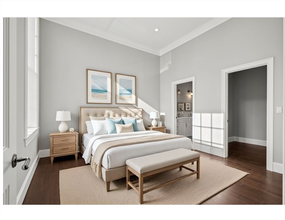 20 Mechanic Square, Unit 2 Marblehead, MA 01945 - Photo 22 of 42 a bedroom with a bed a table and wooden floor