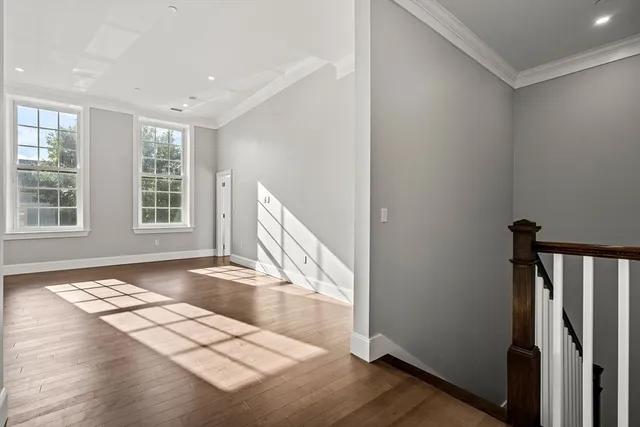 a view of a livingroom with wooden floor and a window