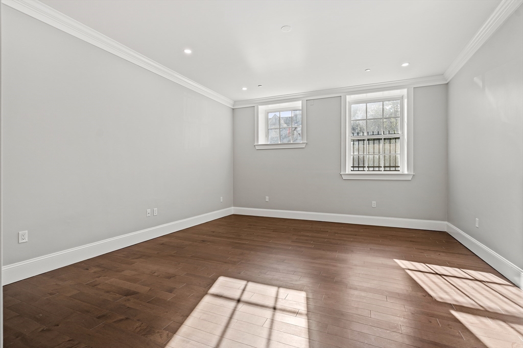 20 Mechanic Square, Unit 2 Marblehead, MA 01945 - Photo 34 of 42 an empty room with wooden floor and windows