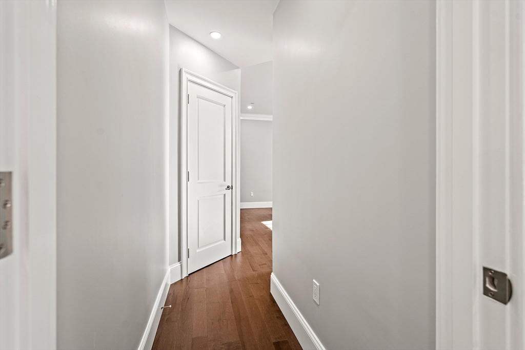 20 Mechanic Square, Unit 2 Marblehead, MA 01945 - Photo 36 of 42 a view of a hallway with wooden floor