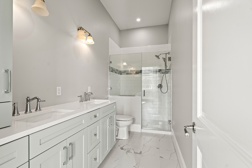 20 Mechanic Square, Unit 2 Marblehead, MA 01945 - Photo 39 of 42 a bathroom with a double vanity sink toilet and shower