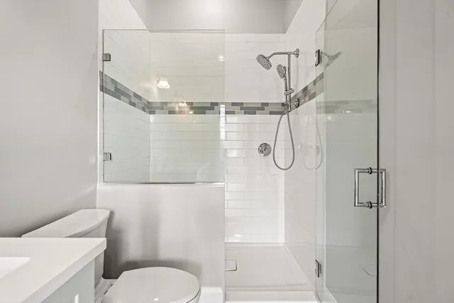 a bathroom with a shower toilet and sink