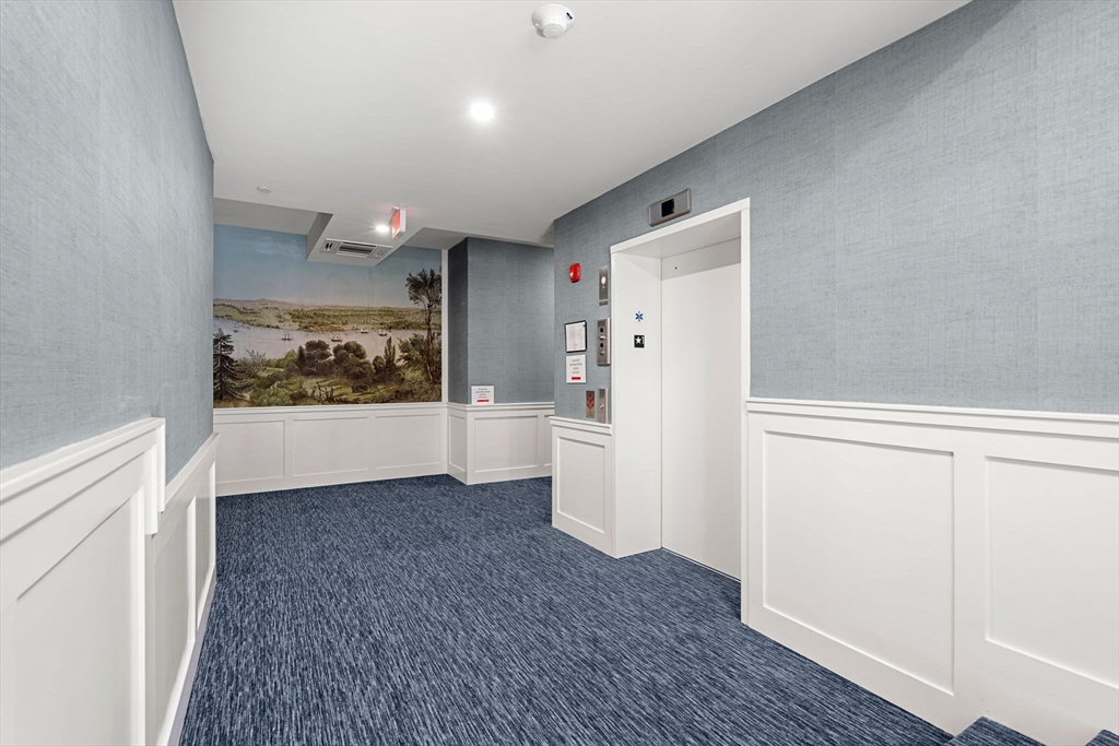 20 Mechanic Square, Unit 2 Marblehead, MA 01945 - Photo 4 of 42 a view of a hallway with wooden floor and closet