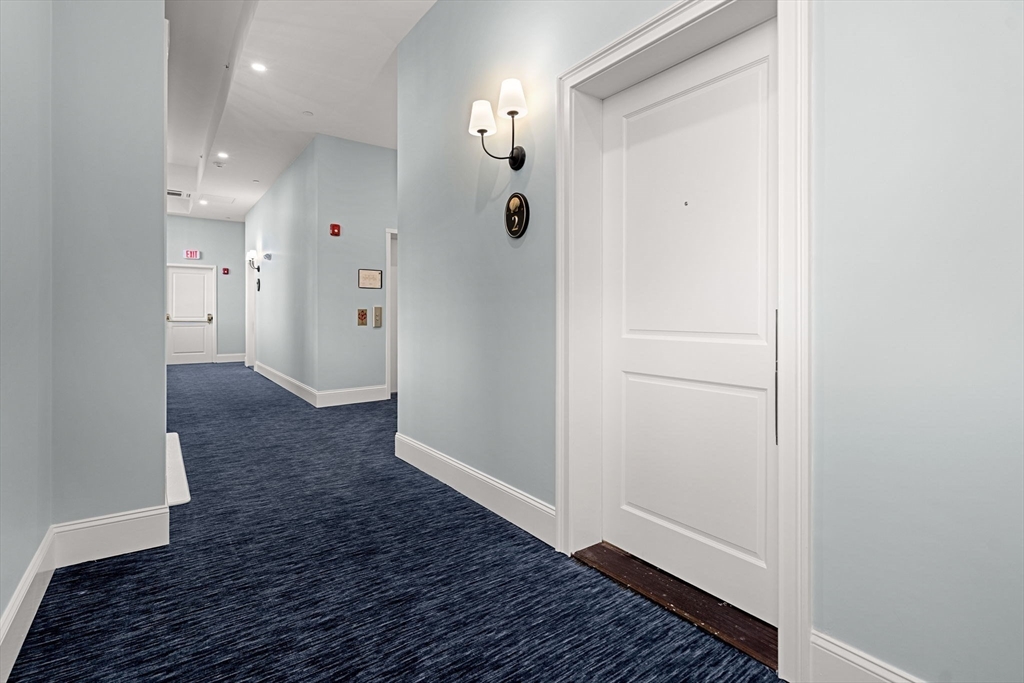 20 Mechanic Square, Unit 2 Marblehead, MA 01945 - Photo 6 of 42 a view of a hallway with wooden floor