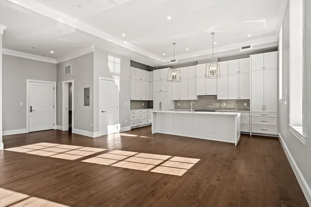 a large kitchen with kitchen island a sink stainless steel appliances and cabinets