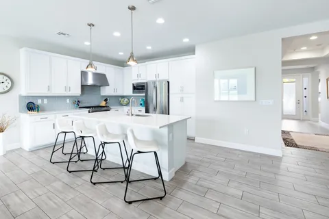 a view of a livingroom with furniture wooden floor and windows