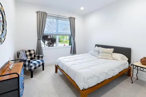 a bathroom with a granite countertop sink toilet mirror and bathtub