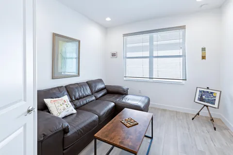 a front view of multiple houses with yard