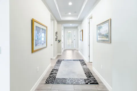 a kitchen with stainless steel appliances kitchen island granite countertop a table chairs in it and wooden floors