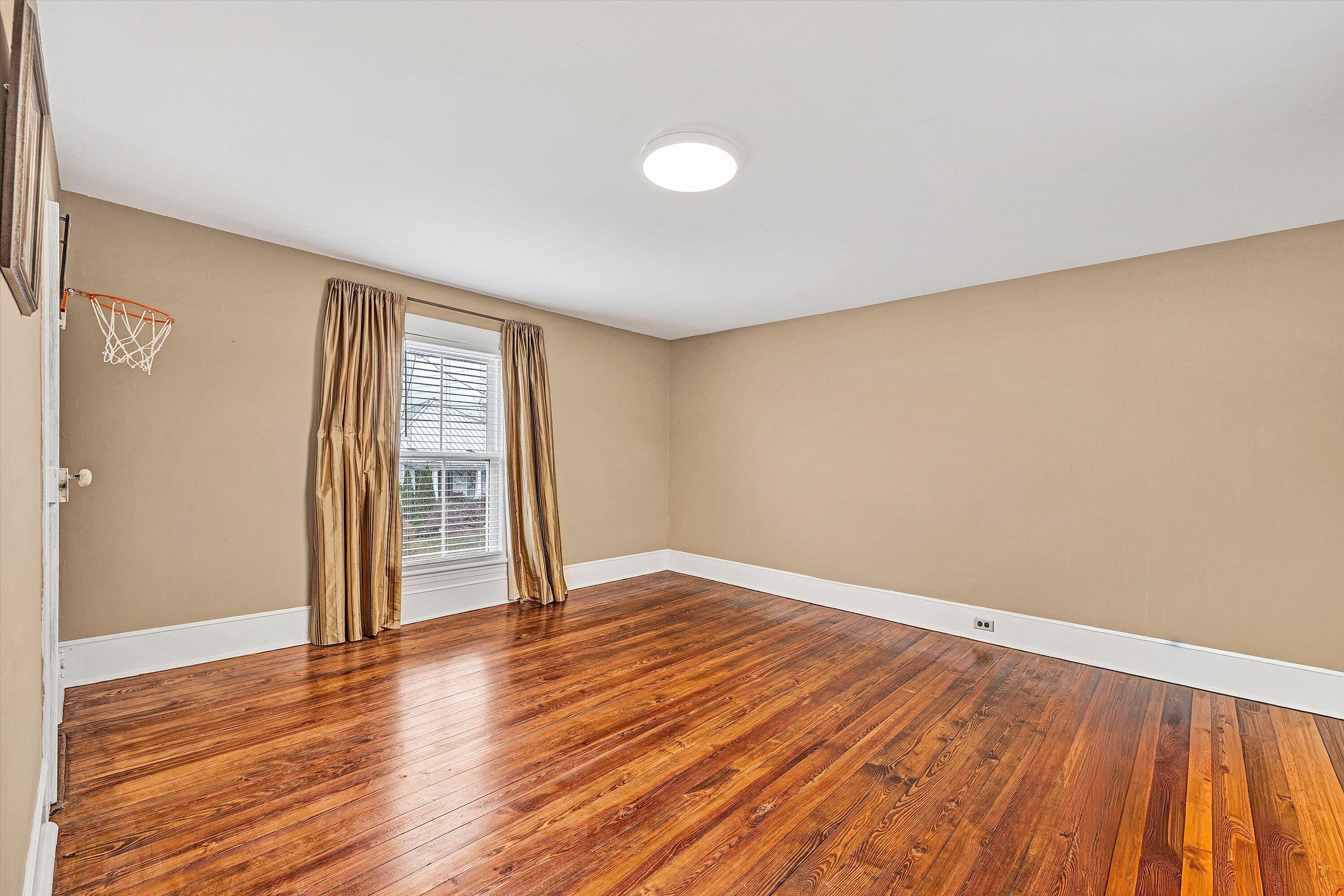 40 High Street Rocky Mount, VA 24151 - Photo 22 of 36 an empty room with wooden floor and windows