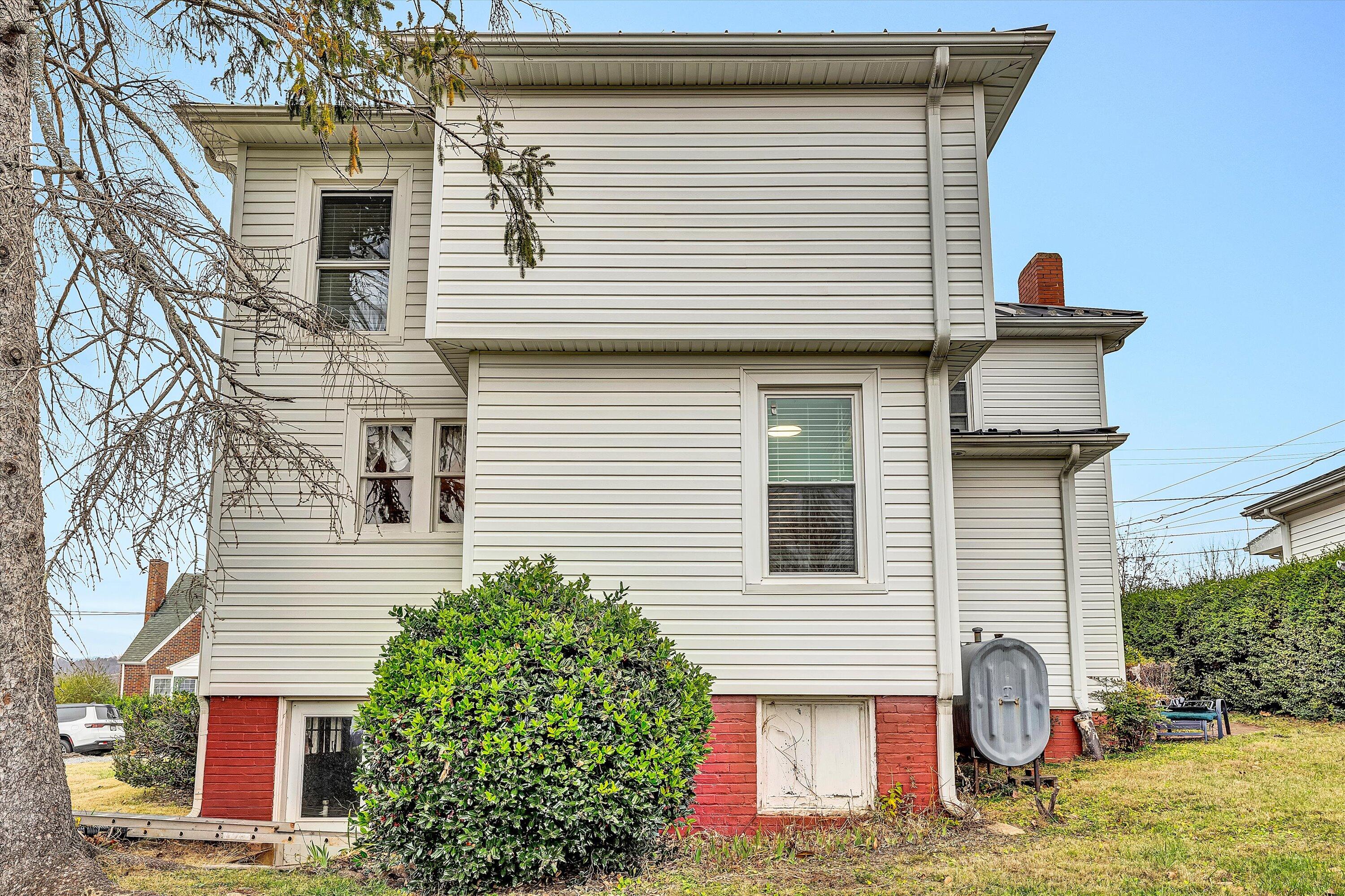 40 High Street Rocky Mount, VA 24151 - Photo 29 of 36 a view of a white house with large windows and potted plants