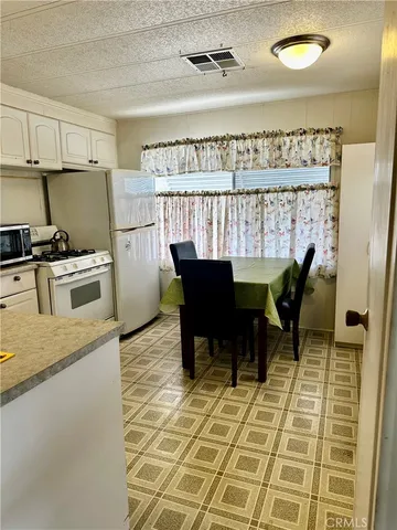a kitchen with a dining table and chairs