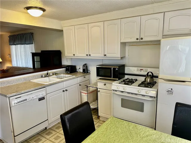 a kitchen with a stove sink and cabinets