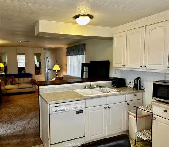 a view of a kitchen counter space and a sink