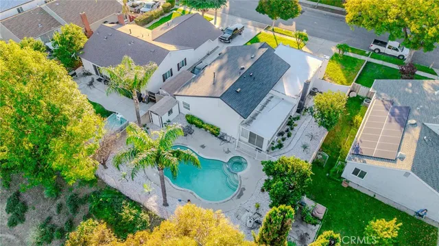 an aerial view of a house with a yard and swimming pool